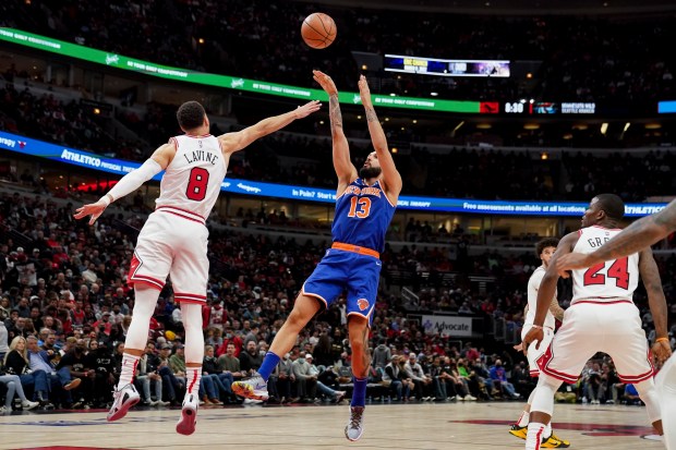 New York Knicks guard Evan Fournier (13) takes a shot over Chicago Bulls guard Zach LaVine (8) during the second half at the United Center Thursday Oct. 28, 2021 in Chicago. (Armando L. Sanchez/Chicago Tribune)