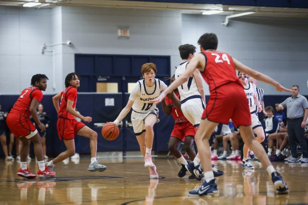 Oswego East's Noah Mason (10) dribbles down court during a game against West Aurora in Oswego on Friday Feb. 2, 2024. (Troy Stolt for the Aurora Beacon News)