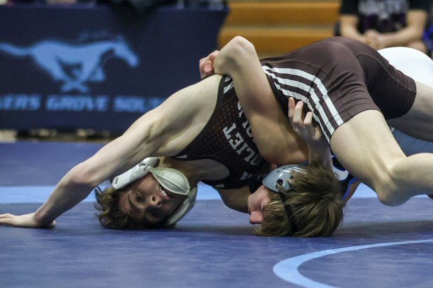 Joliet Catholic's Max Cumbee wrestles Lincoln-Way East's JT Theis during the 113 pound match of the the Class 3A Downers Grove South Dual Team Sectional match between Joliet Catholic and Lincoln-Way East in Downers Grove on Tuesday Feb. 20 2024. (Troy Stolt for the Daily Southtown)