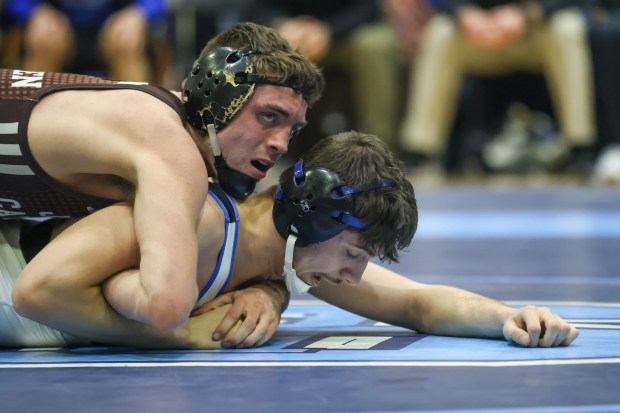 Joliet Catholic's Connor Cumbee wrestles Lincoln-Way East's Domanic Abuja during the 150 pound match of the the Class 3A Downers Grove South Dual Team Sectional match between Joliet Catholic and Lincoln-Way East in Downers Grove on Tuesday Feb. 20 2024. (Troy Stolt for the Daily Southtown)