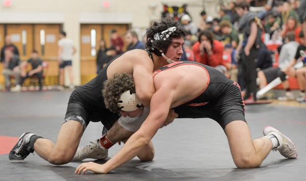 West Aurora's Noah Quintana wrestles Naperville Central's Christopher Bern at 157 pounds during the finals of the Class 3A East Aurora Regional in Aurora on Saturday, Feb. 3, 2024. (Mark Black / The Beacon-News)