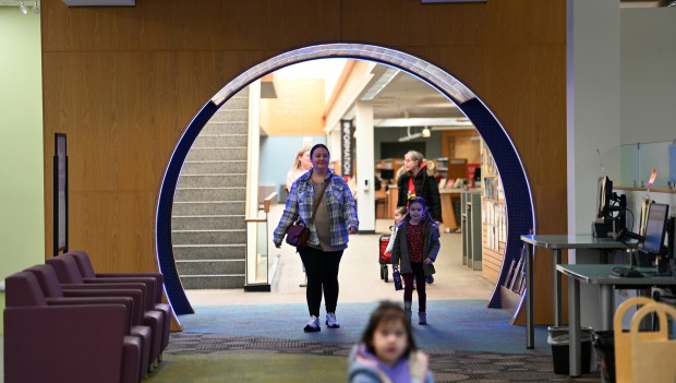 From left to right, Sejla Filipovic of Arlington Heights arrives to Kids' World with daughter Ayla Filipovic, 4, at the Arlington Heights Memorial Library on Feb. 1, 2024 in Arlington Heights.