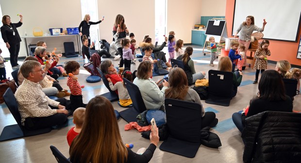Top far right, Kerry Bailey, tween librarian, makes fun gestures during Toddler Time at Kids' World in the Arlington Heights Memorial Library on Feb. 1, 2024 in Arlington Heights.