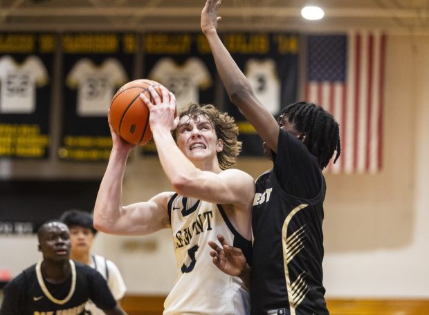 Lemont's Shea Glotzbach (15) goes in hard to the basket against Oak Forest's Je'Sean Shannon during the Class 3A Marian Catholic Regional semifinals in Chicago Heights on Wednesday, Feb. 21, 2024. (Vincent D. Johnson / Daily Southtown).