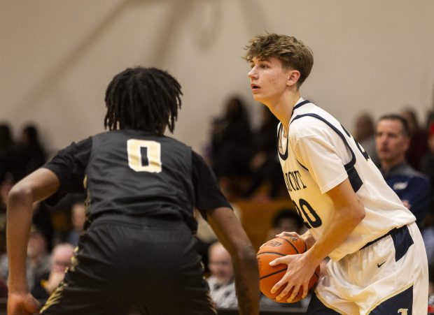 Lemont's Matas Gaidukevicius (20) holds the ball on the perimeter against Oak Forest during the Class 3A Marian Catholic Regional semifinals in Chicago Heights on Wednesday, Feb. 21, 2024. (Vincent D. Johnson / Daily Southtown).