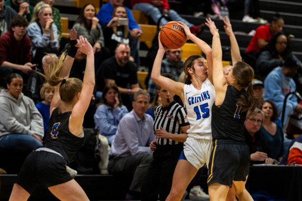 Lincoln-Way East's Lilly Dockemeyer (15) is boxed in by Sandburg's Ellen Driscoll (4) and Grace Fuller (1) during the Class 4A Joliet West Sectional semifinals in Joliet on Tuesday, Feb. 20, 2024. (Vincent D. Johnson / Daily Southtown).