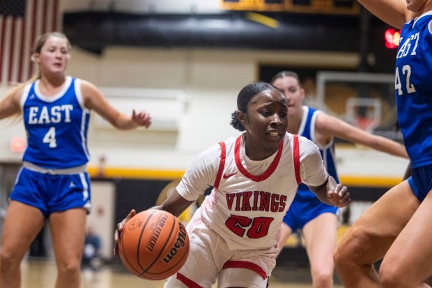 Homewood-Flossmoor's Jaeda Murphy (20) drives towards Lincoln-Way East's Hayven Smith (42) during the Class 4A Joliet West Sectional final in Joliet on Thursday, Feb. 22, 2024. (Vincent D. Johnson / Daily Southtown)