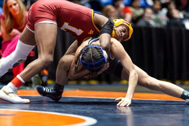 Lockport's Morgan Turner wraps up Joliet Township's Eliana Paramo in the girls wrestling championship match at 110 pound at Grossinger Motors Arena in Bloomington on Saturday, Feb. 24, 2024. (Vincent D. Johnson / Daily Southtown)