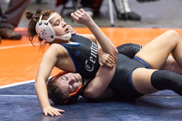 Burlington Central's Victoria Macias, top wrestles against DeKalb's Reese Zimmer in the girls wrestling fifth-place match at 115 pound in the state meet at Grossinger Motors Arena in Bloomington on Saturday, Feb. 24, 2024. (Vincent D. Johnson / Beacon-News)