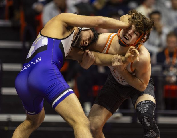 St. Charles East's Ben Davino's, right, wrestles against Hononega's Thomas Silva during the 132 pound bout in the class 3A state wrestling championship at the State Farm Center at University of Illinois in Champaign on Saturday, Feb. 17, 2024. (Vincent D. Johnson / Daily Southtown).