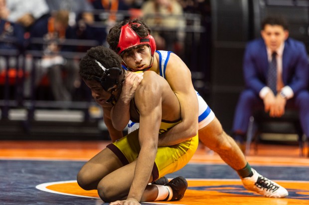 Marmion's Zach Stewart tries to control Lockport's Justin Wardlow during the 138 pound bout in the class 3A state wrestling championship at the State Farm Center at University of Illinois in Champaign on Saturday, Feb. 17, 2024. (Vincent D. Johnson / Daily Southtown).