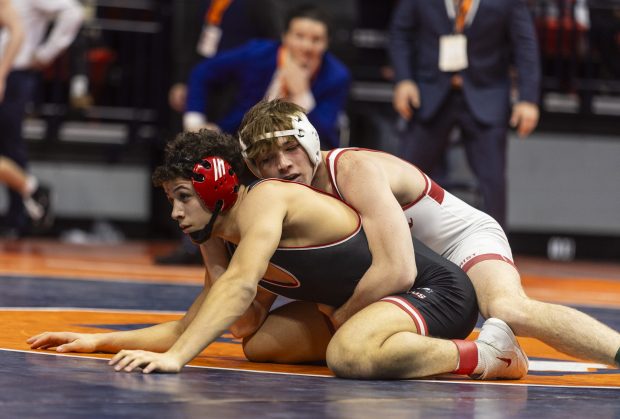 Marist's Will Denny tries to keep Barington's Rhenzo Augusto down during the 150 pound bout in the class 3A state wrestling championship at the State Farm Center at University of Illinois in Champaign on Saturday, Feb. 17, 2024. (Vincent D. Johnson / Daily Southtown).