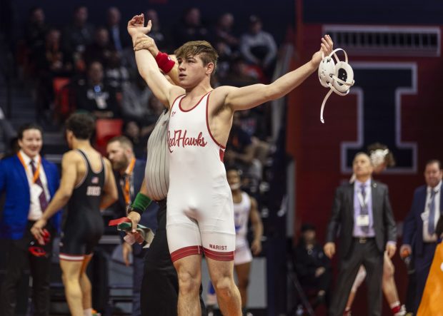 Marist's Will Denny declared a champion after beating Barington's Rhenzo Augusto during the 150 pound bout in the class 3A state wrestling championship at the State Farm Center at University of Illinois in Champaign on Saturday, Feb. 17, 2024. (Vincent D. Johnson / Daily Southtown).