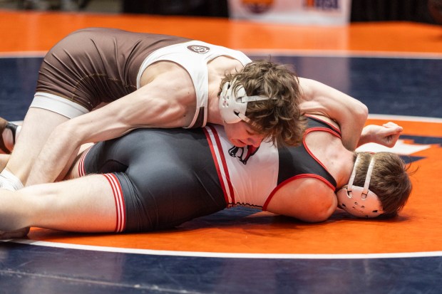 Mount Carmel's Eddie Enright truest roll over Yorkville's Cameron Peach at 157 pound during the Class 3A dual team state wrestling championship match at Grossinger Motors Arena in Bloomington on Saturday, Feb. 24, 2024. (Vincent D. Johnson / Daily Southtown)