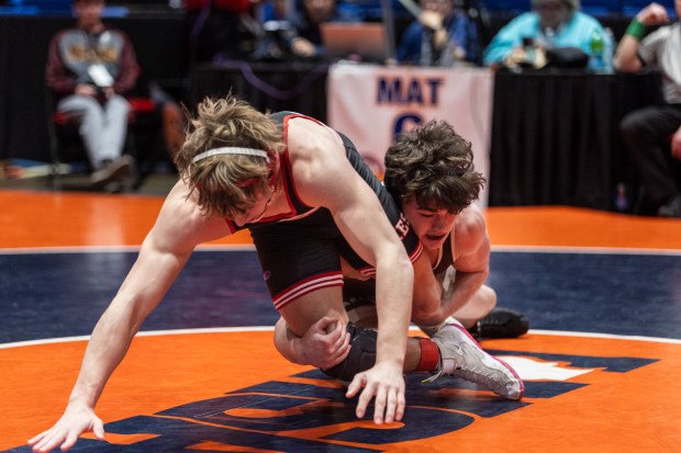 Mount Carmel's Colin Kelly grabs both of Yorkville's Luke Took's legs on a take down at 175 pound during the Class 3A dual team state wrestling championship match at Grossinger Motors Arena in Bloomington on Saturday, Feb. 24, 2024. (Vincent D. Johnson / Daily Southtown)