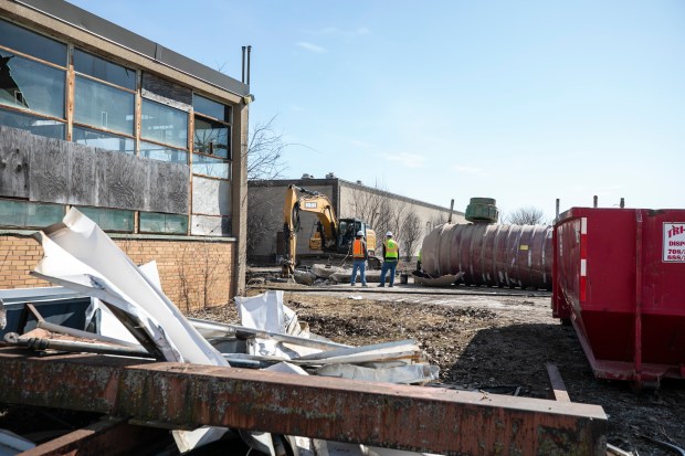 Workers remove underground fuel storage tanks at the site of the former Tinley Park Mental Health Center in Tinley Park on Monday, Feb. 26, 2024. (Vincent D. Johnson / Daily Southtown)