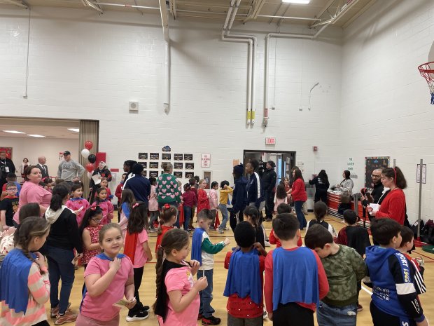 Students mingle in the gym following the scooter giveaway on Feb. 14. (Hank Sanders/Daily Southtown)