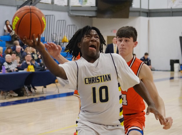 Yorkville Christian's Jayden Riley (10) lays the ball up in front of Gardner-South Wilmington's Cole Hampson during a Class 1A Aurora Christian Regional quarterfinal game in Yorkville on Monday, February 19, 2024.(Jon Cunningham for The Beacon-News)