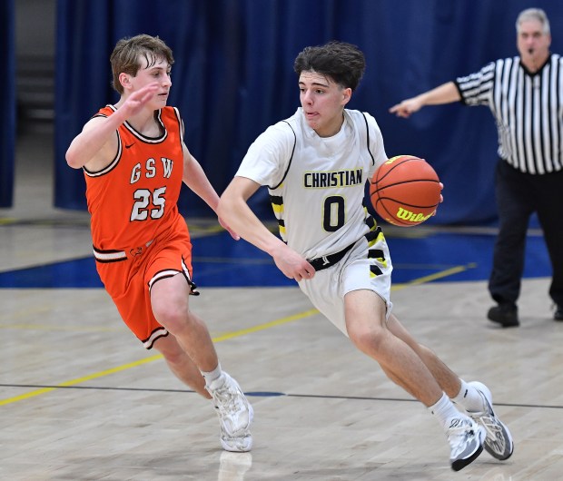 Yorkville Christian's Zach Marini (0) drives as Gardner-South Wilmington's Jarrek Hirsch (25) defends during a Class 1A Aurora Christian Regional quarterfinal game in Yorkville on Monday, February 19, 2024.(Jon Cunningham for The Beacon-News)