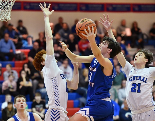 Marmion's Evan Stumm goes to the basket between Burlington Central defenders Patrick Shell and Patrick Magan (21) during a Class 3A Marmion Regional semifinal game in Aurora on Wednesday, February 21, 2024.(Jon Cunningham for The Beacon-News)