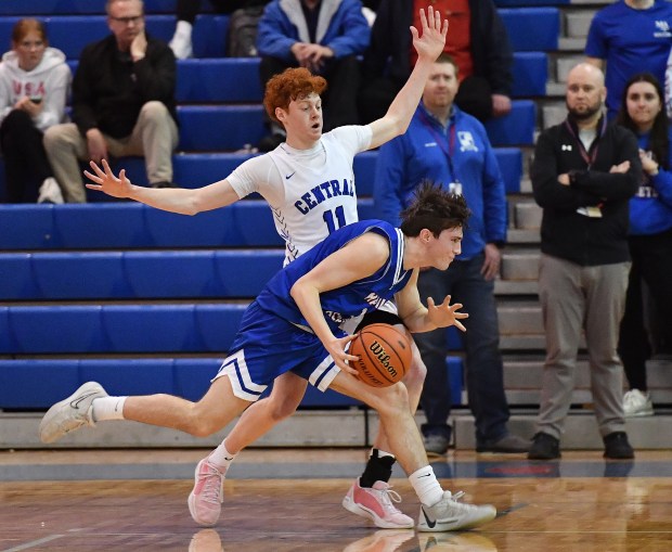 Marmion's Evan Stumm drives past Burlington Central's Patrick Shell (11) during a Class 3A Marmion Regional semifinal game in Aurora on Wednesday, February 21, 2024.(Jon Cunningham for The Beacon-News)