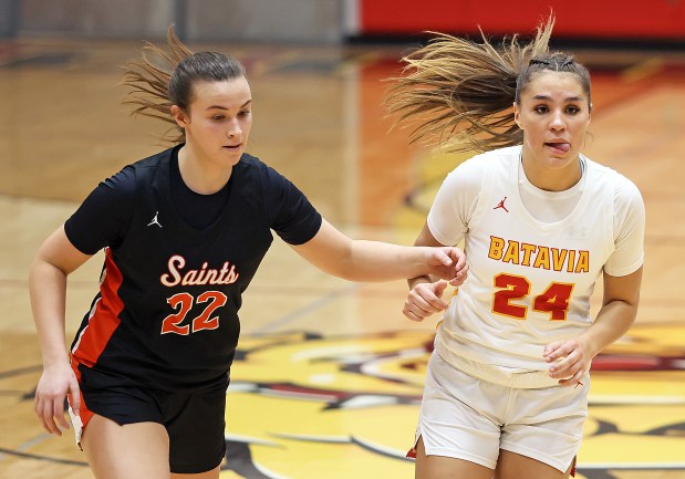 Batavia's Hallie Crane (24) works past St. Charles East's Sydney Axelsen (22) during a Class 4A Batavia Sectional semifinal game on Tuesday, Feb. 20, 2023 in Batavia.H. Rick Bamman / For the Beacon-News