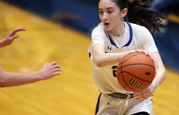 Aurora Central Catholic's Brooklyn Murphy (22) controls a pass around a Marengo defender during a Class 2A Genoa-Kingston Regional semifinal game on Tuesday, Feb. 13, 2024 in Genoa.H. Rick Bamman / For the Beacon News