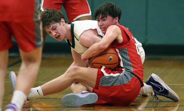 Aurora Christian's Jacob Baumann (22) wrestles the ball away from St. Edward's Matthew Morrice (2) during a Chicagoland Christian Conference game on Tuesday, Jan. 30, 2024 in Elgin.H. Rick Bamman / For the Beacon News