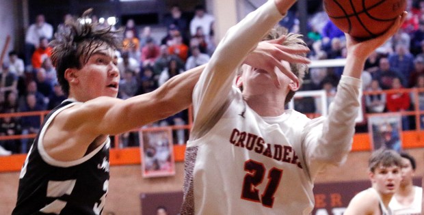 Brother Rice's Caden Workman (21) gets a slap in the face by Mt. Carmel's Angelo Ciaravino during a basketball game in Chicago on Friday, February 9, 2024. (John Smierciak / Daily Southtown)