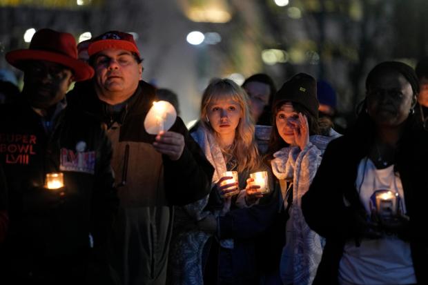 People attend a candlelight vigil for victims of a shooting at a Kansas City Chiefs Super Bowl victory rally Feb. 15, 2024 in Kansas City, Mo. More than 20 people were injured and one woman killed in the shooting near the end of Wednesday's rally held at nearby Union Station. (Charlie Riedel/AP)