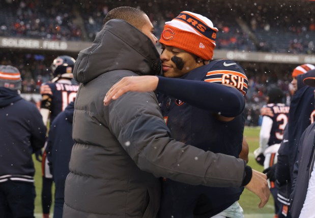 Bears quarterback Justin Fields hugs general manager Ryan Poles as they celebrate a win over the Falcons on Dec. 31, 2023, at Soldier Field.