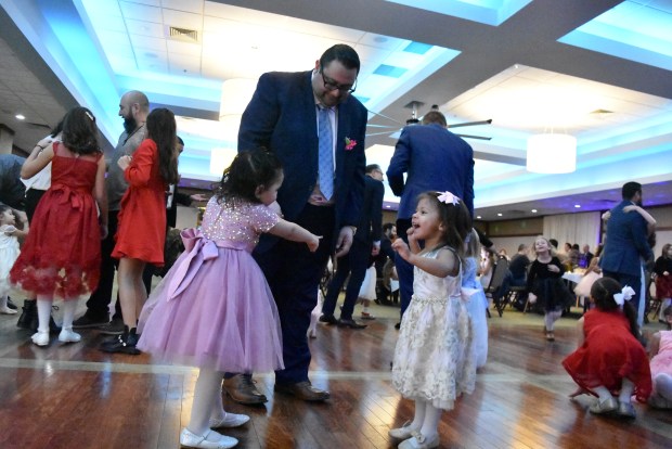 Fathers and their daughters hit the dance floor Feb. 3, 2024 at the "Daddy-Daughter Dance" hosted by the Park District of Franklin Park at the North Park Banquet Hall in Franklin Park.