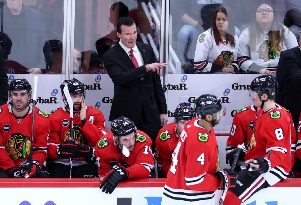 Chicago Blackhawks head coach Luke Richardson relays some information to his team in overtime of a game against the San Jose Sharks at the United Center on Tuesday, Jan. 16, 2024.