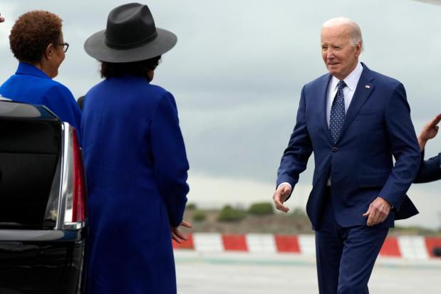 President Joe Biden greets Los Angeles Mayor Karen Bass, left, and Rep. Maxine Waters, D-Calif., as he arrives at Los Angeles International Airport, Tuesday, Feb. 20, 2024, in Los Angeles. (AP Photo/Manuel Balce Ceneta)