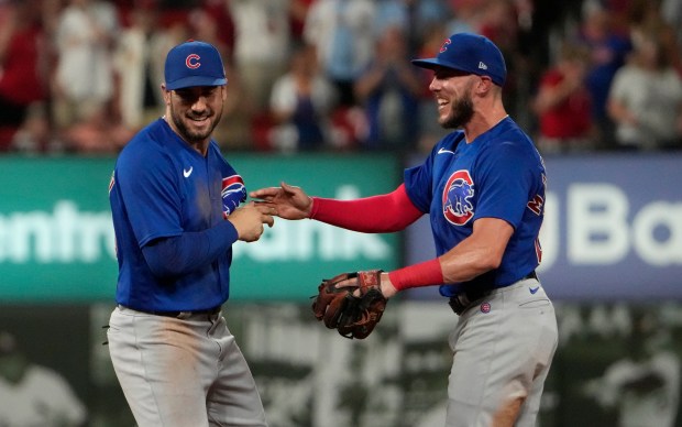 Cubs center fielder Mike Tauchman, left, is congratulated by Miles Mastrobuoni after making a game-saving catch at the wall against the Cardinals on July 30, 2023, in St. Louis. The Cubs won 3-2. (Jeff Roberson/AP)