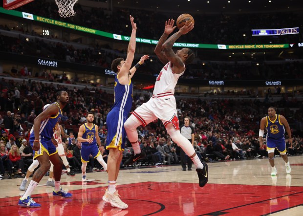 Bulls forward DeMar DeRozan draws a foul from Warriors guard Klay Thompson in the fourth quarter on Jan. 12, 2024, at the United Center.