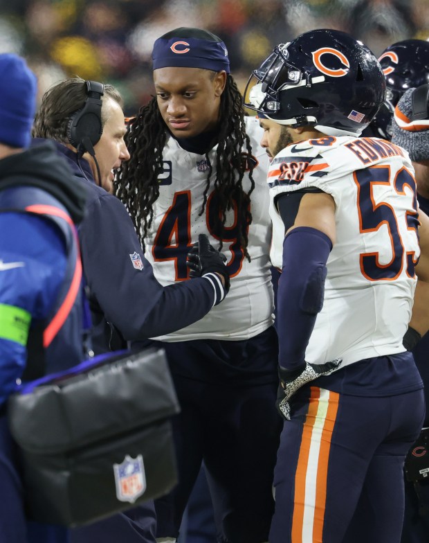 Bears coach Matt Eberflus talks to linebackers Tremaine Edmunds (49) and T.J. Edwards (53) in the fourth quarter against the Packers on Sunday, Jan. 7, 2024, at Lambeau Field.