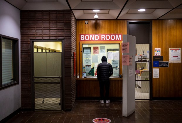 A man pays a cash bail in the bond office on Dec. 21, 2022, at Division 5 of Cook County Jail. Lawmakers abolished cash bail and overhauled the pretrial court system through historic reforms that took effect on Sept. 18, 2023.