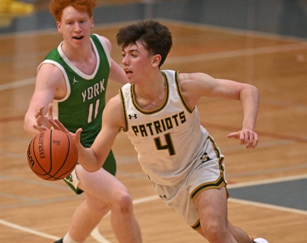 Stevenson's Aidan Bardic (4) gets past York's Ryan Pechous (11) during the 4th quarter of Saturday's game at the Ed Molitor Thanksgiving Classic hosted by Palatine High School, November 25, 2023. Stevenson won the game, 53-50. (Brian O'Mahoney for the News-Sun)