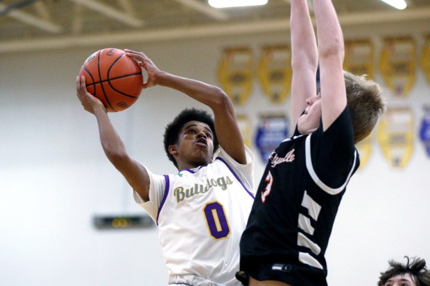 Waukegan's Carter Newsome (0), getting his jumper around Libertyville's Ben Van Lyssel (right), during the Class 4A Warren Regional semifinal on Wednesday, February 21, 2024, in Gurnee.  (Mark Ukena for Lake County News-Sun)