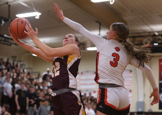 Libertyville guard Lily Fisher (3) attempts to block a layup from Loyola guard Kelsey Langston (22) during the Class 4A Libertyville Supersectional at Libertyville High School in Libertyville on Monday, Feb. 26, 2024. (Trent Sprague/Chicago Tribune)