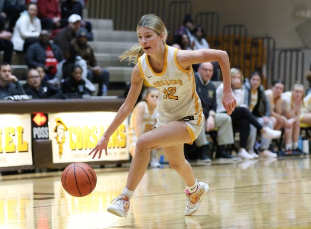 Carmel's Josie Hartman (12) drives to the basket during the Class 4A Carmel Regional semifinal at Carmel Carmel Catholic High School in Mundelein on Monday, Feb. 12, 2024. (Trent Sprague/Chicago Tribune)