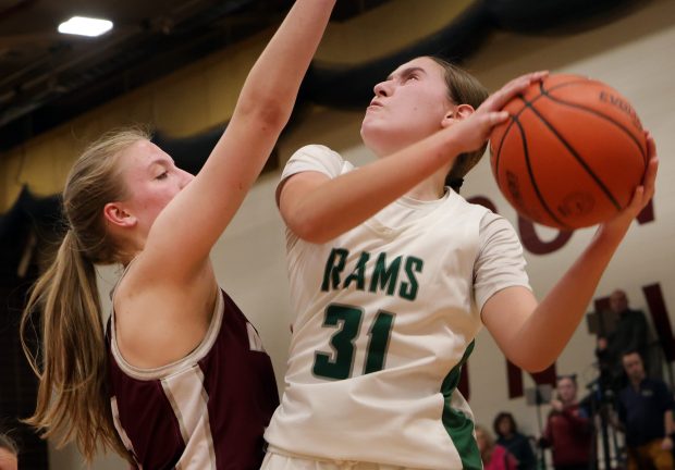 Grayslake Central's Peyton Hoffmann goes up for the basket as Montini's Victoria Matulevicius defend during the Class 3A Concordia Supersectional in River Forest, Ill. Monday, February 26, 2024. (James C. Svehla/for the News Sun)