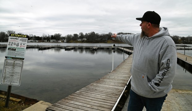Mark Willer of Fox Lake, co-owner of Turtle Beach Marina with spouse Jennifer Willer, points out the location where expanded piers could accommodate more boats to park. Taken on Feb. 10, 2024 at the 64th annual Ice Fishing Derby in Antioch at Turtle Beach Marina on Channel Lake.