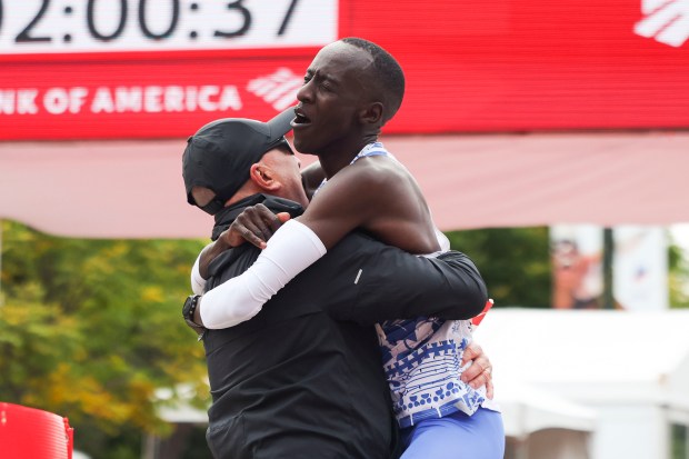 Kelvin Kiptum celebrates his Chicago Marathon victory in world-record time with executive race director Carey Pinkowski on Oct. 8, 2023. (Eileen T. Meslar/Chicago Tribune)