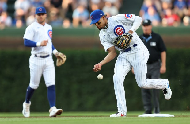 Cubs second baseman Christopher Morel, right, is unable to make a barehanded play on an infield hit by Cardinals first baseman Paul Goldschmidt on July 21, 2023, at Wrigley Field.