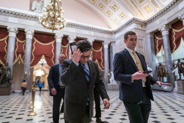 House Speaker Mike Johnson, R-La., walks through statuary Hall as lawmakers gather in the House chamber to vote on the articles of impeachment against Homeland Security Secretary Alejandro Mayorkas for failures on the U.S.- Mexico border at the Capitol in Washington, Feb. 6, 2024.