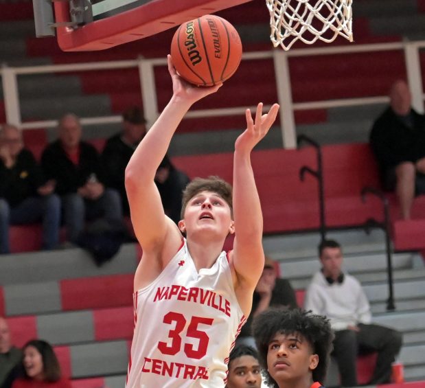 Naperville Central's Jackson First scores a putback in the paint. Naperville Central defeated Oswego, 51-43, in the Class 4A Downers Grove North Regional quarterfinal boys basketball game Monday, February 19, 2024, in Naperville, Illinois. (Jon Langham/photo for Naperville Sun)