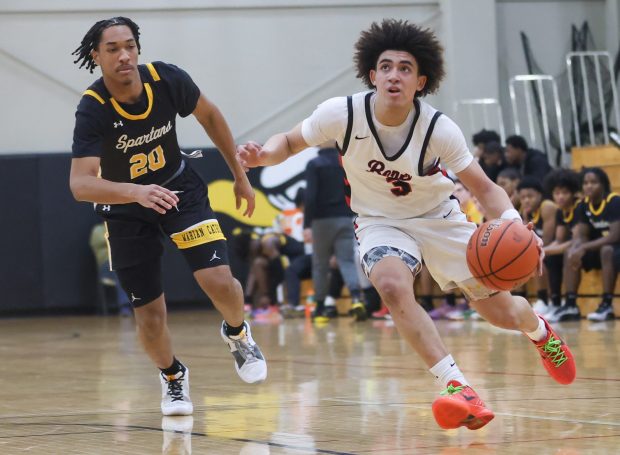 Benet Academy's Jayden Wright (3) drives to the basket during a game against Marian Catholic in Lisle on Sunday Feb. 4, 2024. (Troy Stolt for the Naperville Sun)