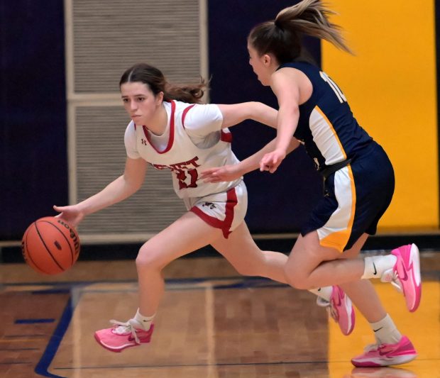 Benet's Ava Mersinger brings the ball upcourt as Neuqua Valley's Zoe Navarro defends. Benet defeated Neuqua Valley, 47-44, in a Class 4A Neuqua Valley Regional championship girls basketball game Thursday, February 15, 2024, in Naperville, Illinois. (Jon Langham/Photo for Naperville Sun)